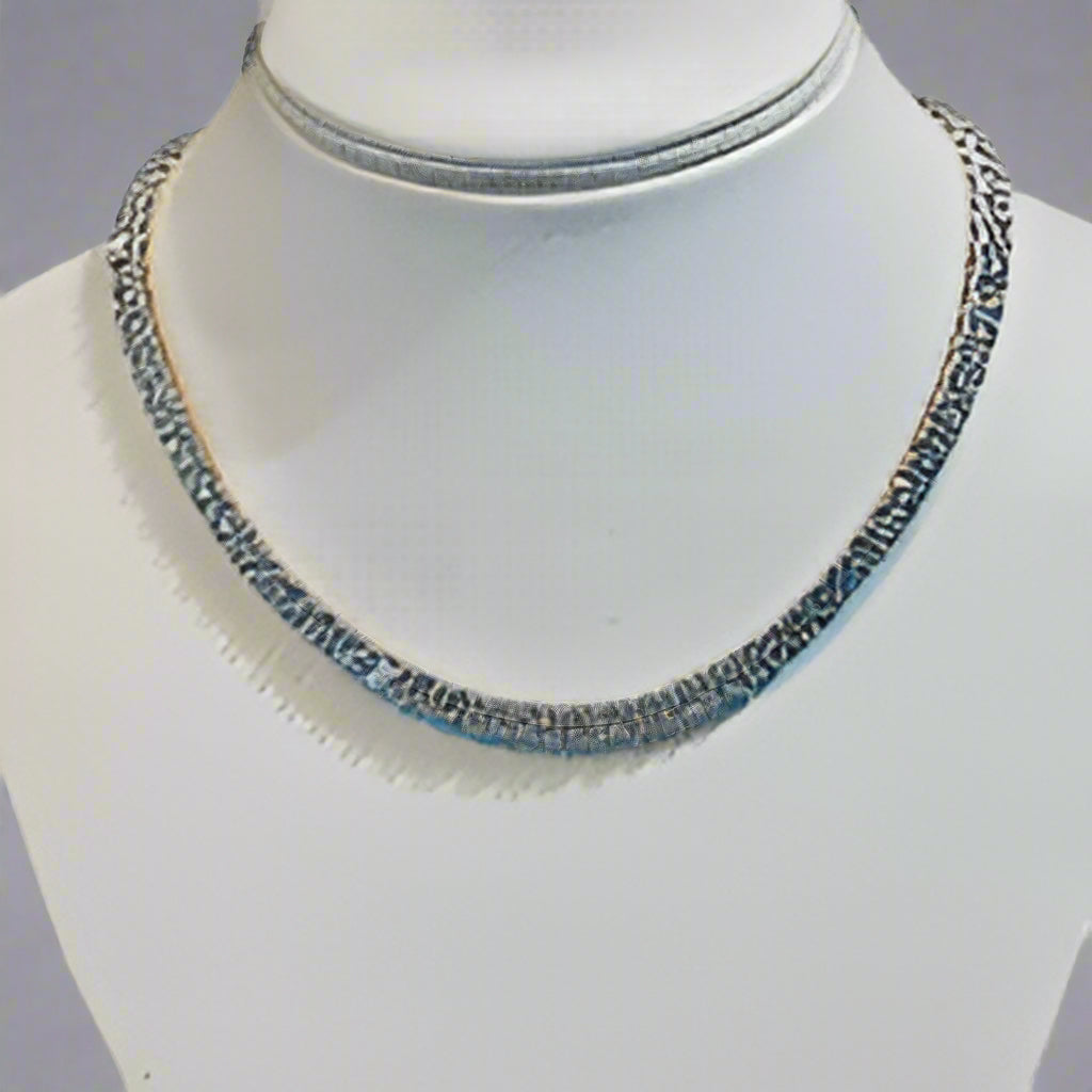 Necklace on a mannequin bust with a blurred background