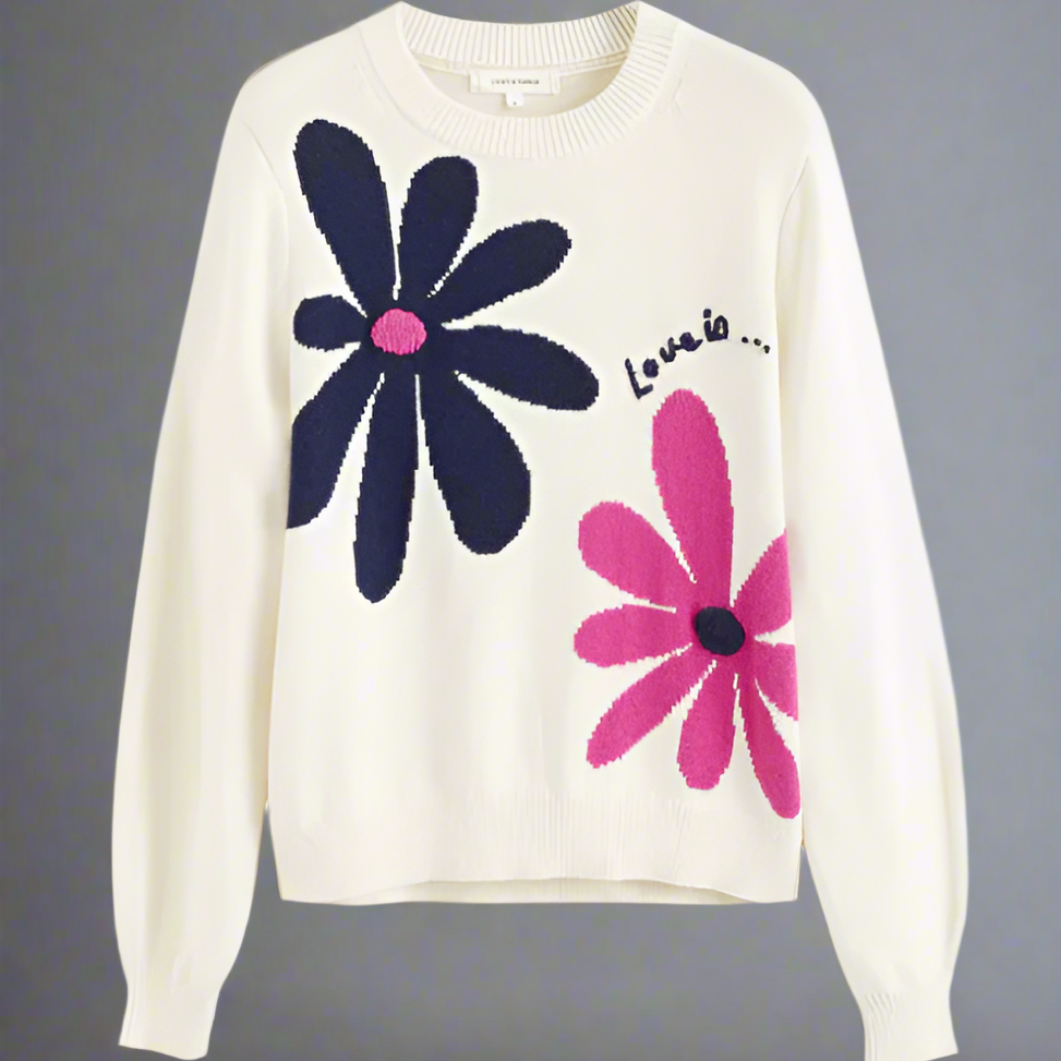 White sweater with large blue and pink floral designs on a white background