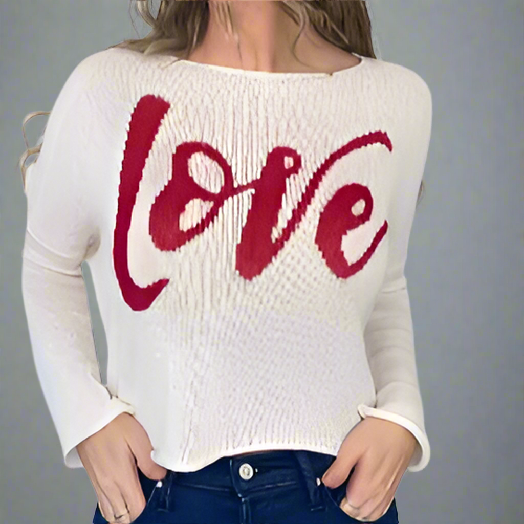 White sweater with red 'LOVE' text worn by a person on a white background