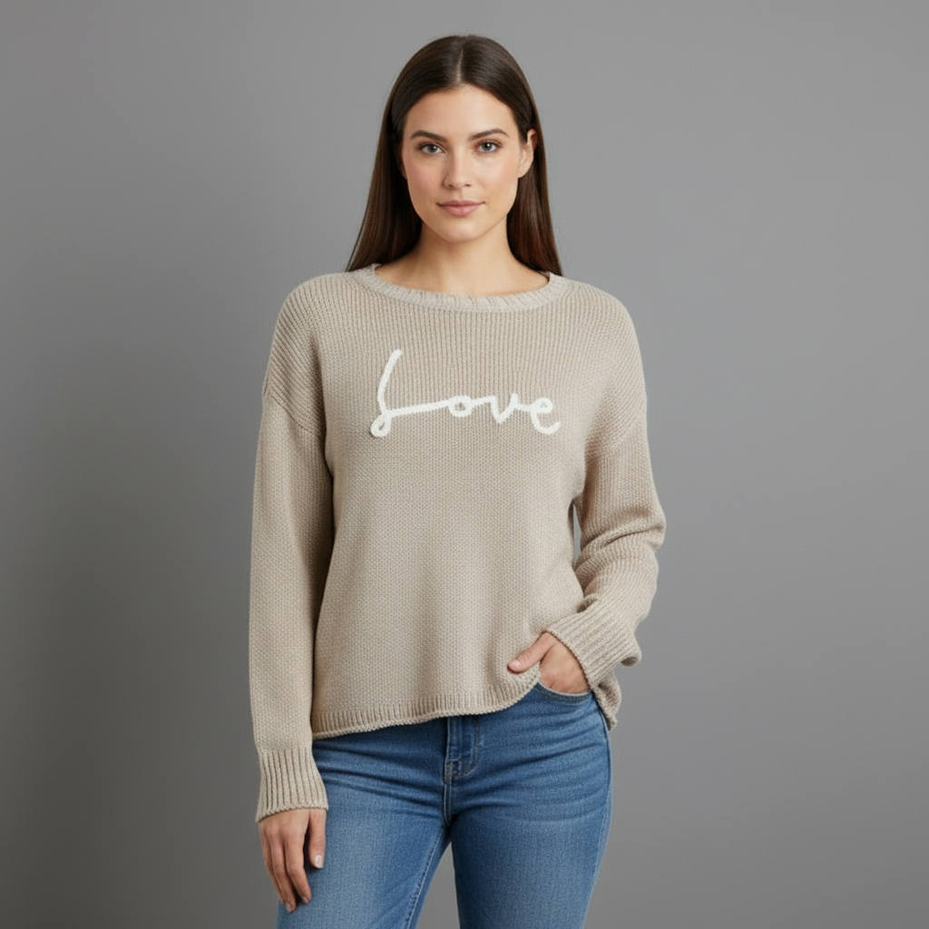 A beige crew sweater with the word 'love' knitted in cursive on the front.