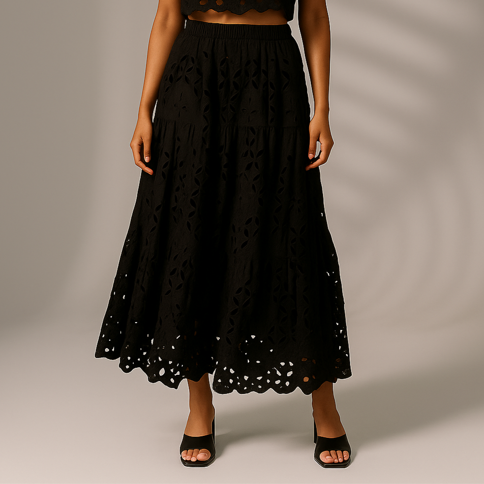 Woman wearing a black strapless top and skirt against a neutral background