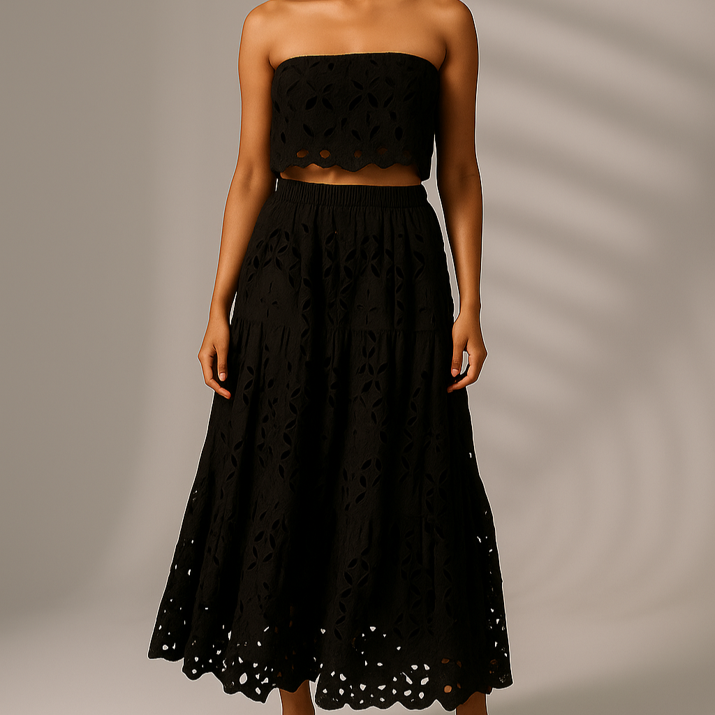 Woman wearing a black strapless top and skirt against a neutral background