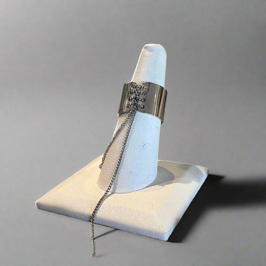 A sterling silver lace-up ring on a white mannequin hand.