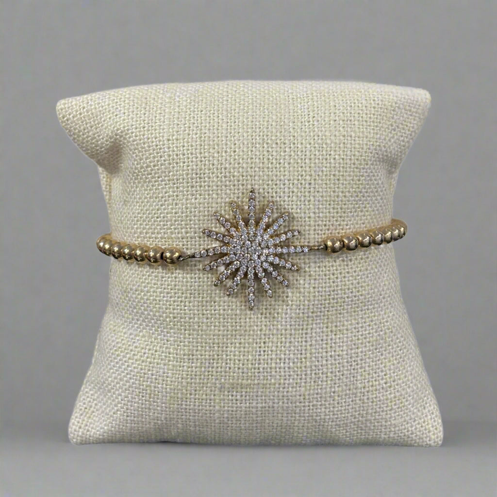 GOLD STARBURST CHARM BRACELET