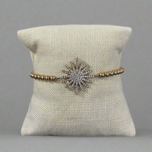 GOLD STARBURST CHARM BRACELET