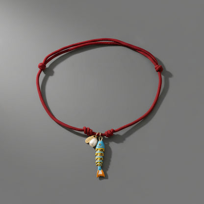 CORDED PEARL FISH NECKLACE