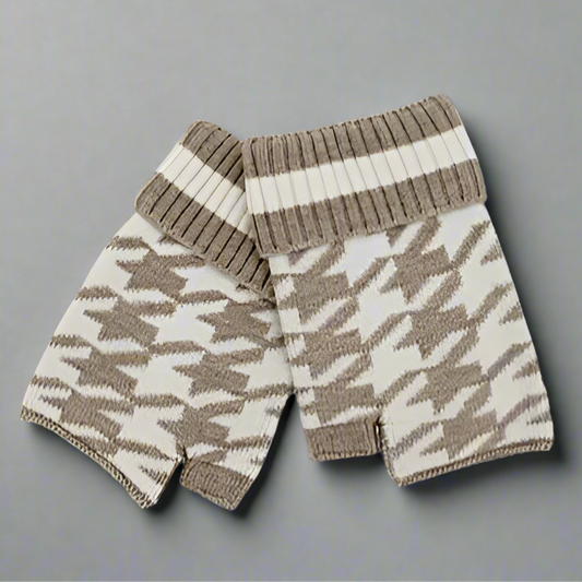 Pair of knitted fingerless gloves with a houndstooth pattern on a dark background
