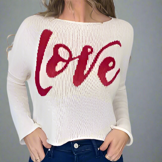 White sweater with red 'LOVE' text worn by a person on a white background