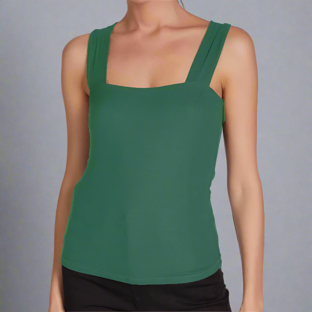 Green tank top worn by a model on a white background