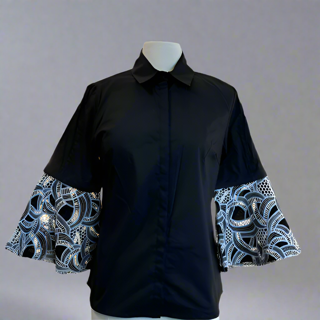 Black shirt with patterned sleeves on a mannequin against a white background