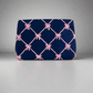 Navy clutch bag with pink bow pattern on a white background