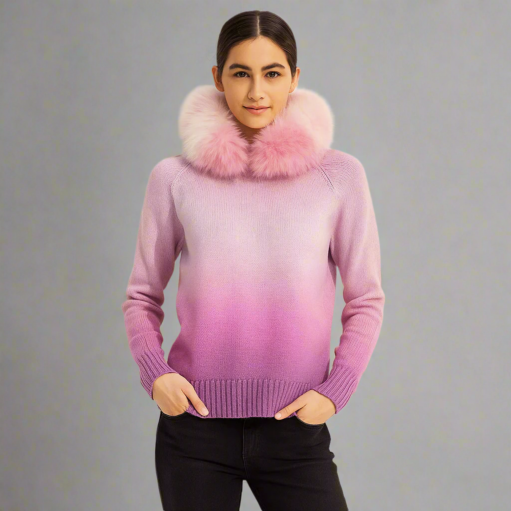 Person wearing a pink gradient sweater with a fur collar against a plain background