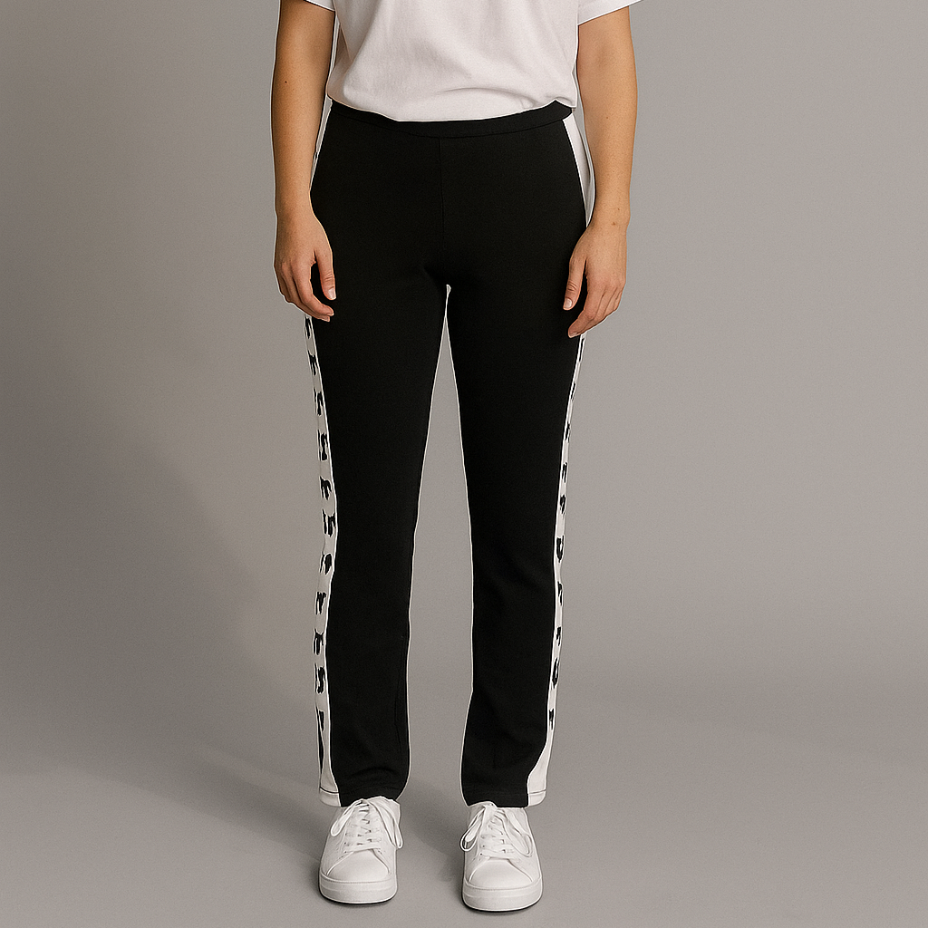 Person wearing a white t-shirt and black pants with white stripes on a gray background