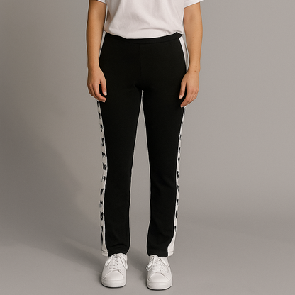 Person wearing a white t-shirt and black pants with white stripes on a gray background