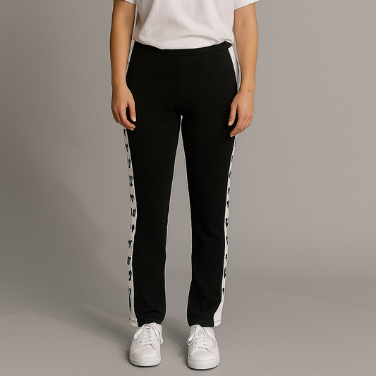 Person wearing a white t-shirt and black pants with white stripes on a gray background