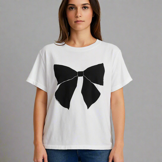 White t-shirt with a black bow design worn by a person on a plain background