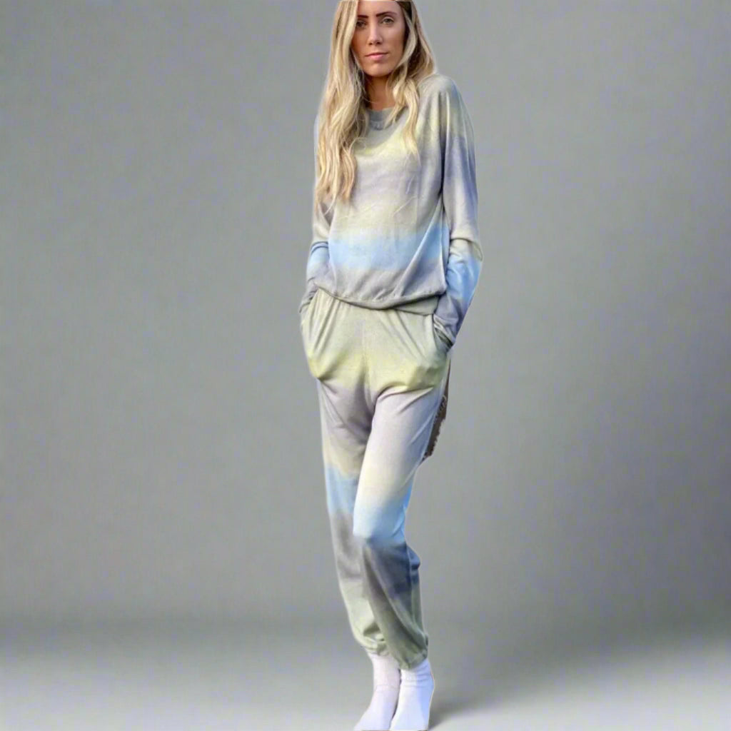 Woman wearing a tie-dye outfit on a white background